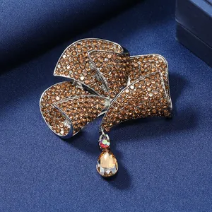 Vintage-style elegant bow brooch with brown crystal rhinestones and teardrop pendant