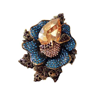 Luxurious vintage crystal flower brooch with blue and champagne rhinestones on bronze base