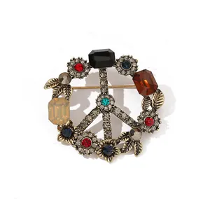 Detailed macro view of a vintage peace sign brooch with colorful crystal rhinestones