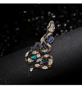 Detailed view of a vintage snake brooch with colorful crystals and black enamel.