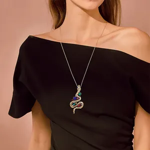 Elegant vintage snake pendant necklace with colorful crystals worn on a black dress.