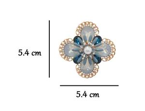 Dimensional detail of floral brooch with blue stones and pearl, measuring 5.4 cm