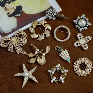 Vintage Baroque brooches collection with matte gold finish and elegant pearls decoration