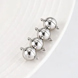 Detailed close-up view of four polished silver round magnetic clasps for DIY jewelry