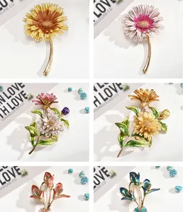 Variety of elegant enamel flower brooches including sunflowers and lilies in vibrant colors