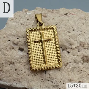Detail shot of gold-plated stainless steel cross pendant on textured stone background.