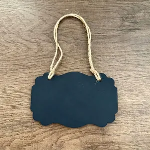 Detailed view of a mini scalloped wooden blackboard tag with natural jute hanging rope