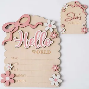 Wooden newborn baby milestone announcement plaque with pink bow and floral decorations