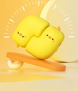 Close-up of two cute yellow duck-shaped magnetic hand warmers on a playful background.
