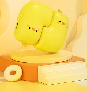Close-up of two cute yellow duck magnetic hand warmers paired on a minimalist yellow stand.