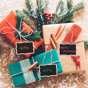 Detailed view of mini wooden chalkboards used as festive Christmas gift tags hanging