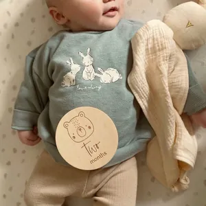 Round wooden baby milestone card for photography featuring a cute bear and months text