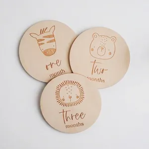 Wooden baby monthly milestone cards with engraved animal faces and text