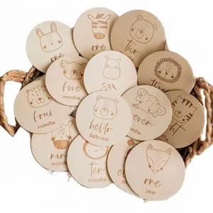 Handcrafted wooden baby monthly milestone cards with cute engraved animal illustrations