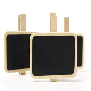 Macro detail of small wooden blackboard clips for tabletop message note display.
