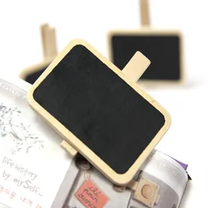 Detailed view of a mini wooden blackboard clip placed on an open lifestyle book.