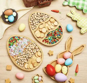 Top-down view of Easter bamboo serving trays filled with various snacks and nuts.