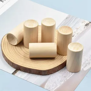 Dettaglio di diffusori cilindrici di oli essenziali in legno naturale su sottobicchiere