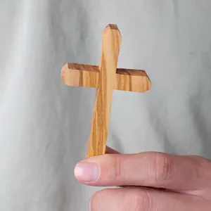 Handmade olive wood cross pendant with natural wood grain texture for gift