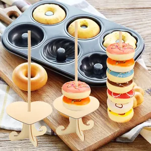 Close-up of heart-shaped wooden donut stands for party dessert table displays