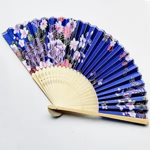 Detailed view of an elegant Japanese folding fan with purple floral patterns and bamboo ribs