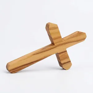 Handmade olive wood cross pendant necklace featuring natural wood grain texture
