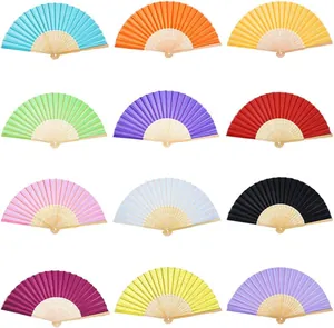 Collection of twelve colorful folding hand fans with natural bamboo ribs on white background