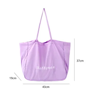 Close-up detail of a large purple canvas tote bag showing dimensions 43cm x 37cm