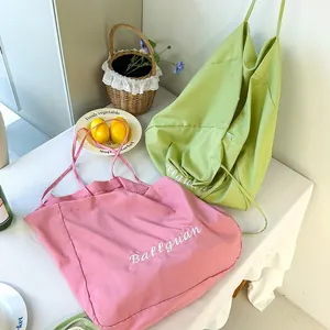Detailed shot of large capacity canvas tote bags in pink and light green colors