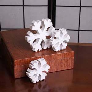 Close-up of white distressed wooden snowflake decorations for Christmas
