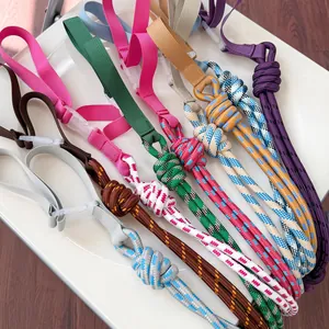 A detailed macro view of various colorful nylon braided shoulder straps for shopping bags