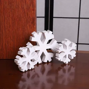 Detail of white distressed wooden snowflake decorations for rustic winter home decor