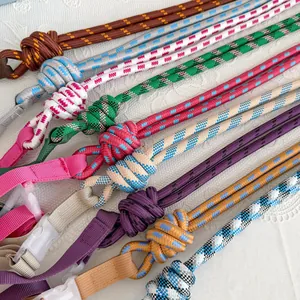 Close-up detail of various colorful braided nylon rope shoulder straps with buckles