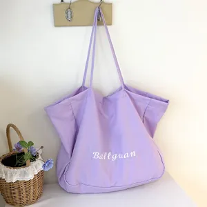 Detail view of lavender fabric tote bag with Ballguan logo, large minimalist shoulder bag