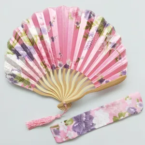 Detailed view of pink floral kimono fan set with matching fabric sleeve and tassel