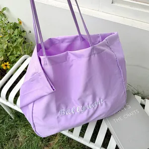 Close-up of a purple minimalist tote bag featuring white Ballguan embroidery detail