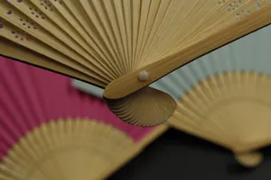 Close-up detail of natural bamboo folding fan ribs with sturdy pivot mechanism