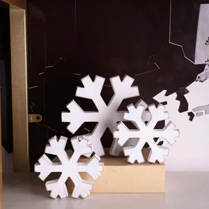 Set of three decorative white distressed wooden snowflake ornaments for Christmas winter home decor