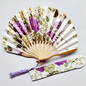 Traditional floral pattern satin folding fan with matching fabric pouch and purple tassel