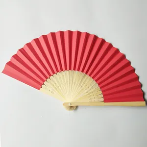 Traditional red folding paper fan with bamboo ribs for DIY wedding favors and decor