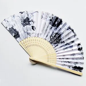 Detail view of a Japanese folding fan with patterned fabric and hollowed bamboo ribs
