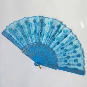 Close-up detail of a bright blue folding fan with shimmering sequins and embroidery.