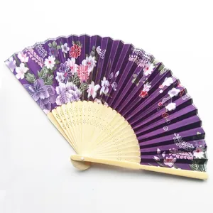 Detailed view of a purple Japanese folding fan with elegant floral patterns on satin cloth