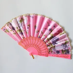 Elegant pink floral folding fan with plastic ribs and gold lace trim for dancing