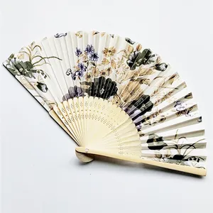 Detail view of Japanese floral folding fan with intricate cutout frame.