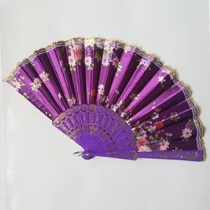 Decorative purple satin folding fan featuring floral print and elegant gold lace trim