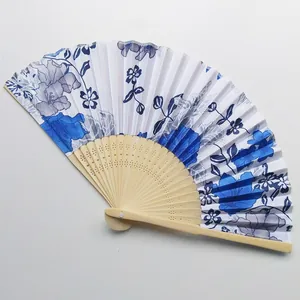 Detailed view of Japanese floral folding fan featuring an intricate bamboo frame