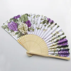 Detail view of a Japanese floral folding fan with purple peonies and bamboo frame