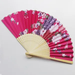 Elegant Japanese floral folding fan featuring delicate hollowed bamboo ribs and satin fabric.