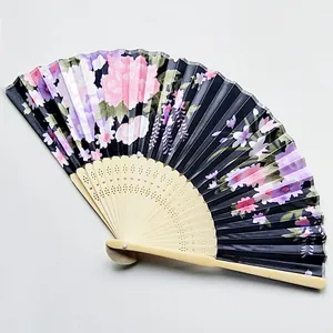 Detailed close-up view of a Japanese-style satin folding fan with floral patterns